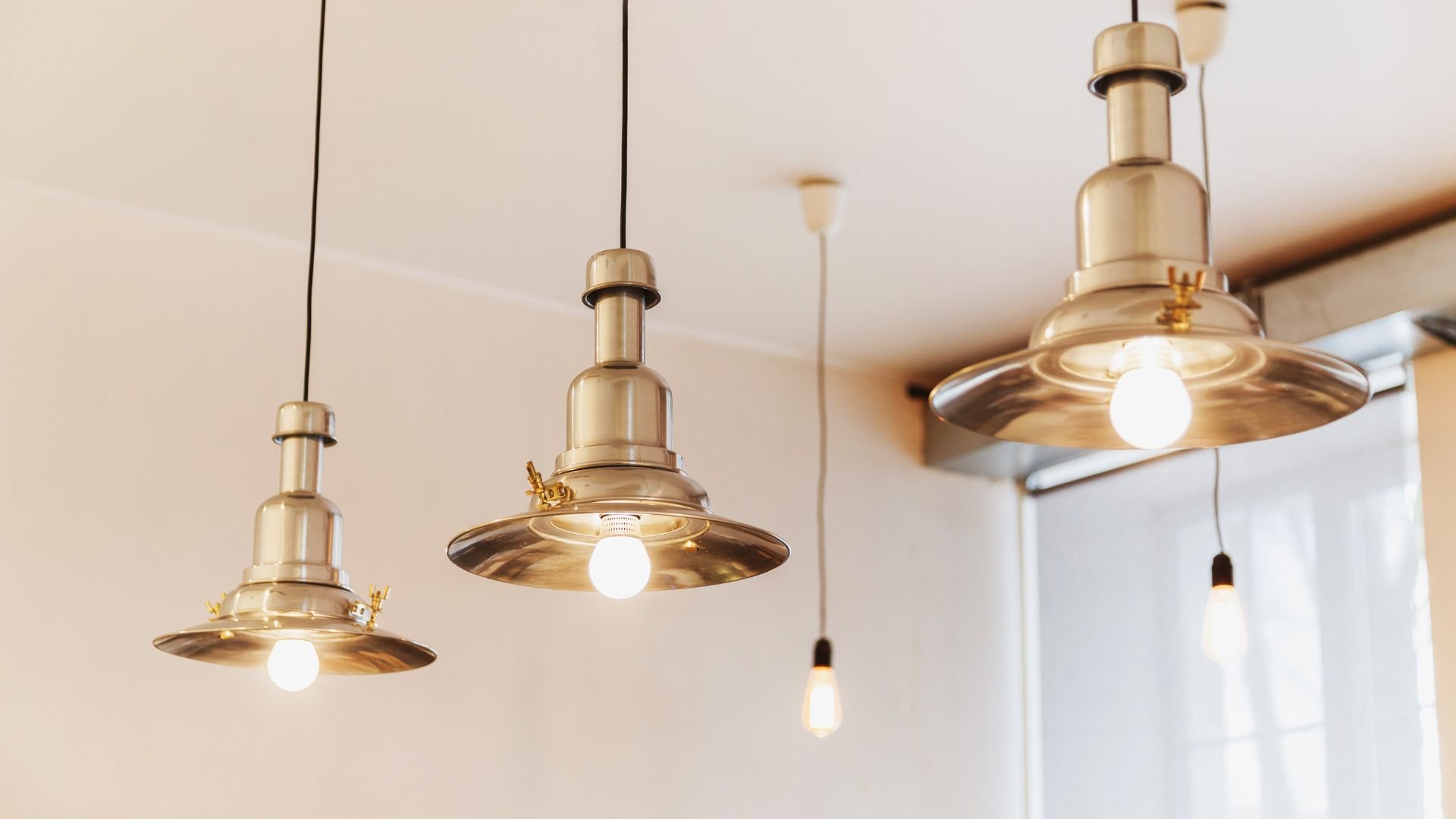 Vintage gold-toned hanging pendant lights with round glass shades